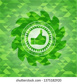 like icon inside green emblem with mosaic background