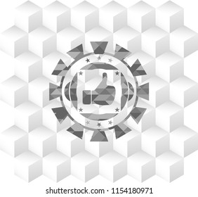 like icon inside grey emblem with geometric cube white background