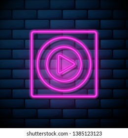 Lilac pink neon sign on brick wall Play icon. Music and video play symbol