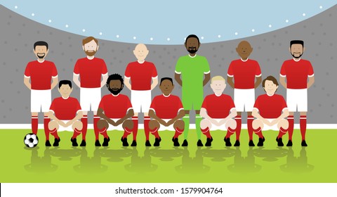 line up of eleven multinational male soccer players in red kit on football pitch. EPS file available.