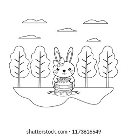 line female rabbit with sweet donuts in the landscape