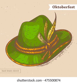 Linear colored sketch of the green hat with feathers and text Oktoberfest. Traditional german clothes for celebrating Oktoberfest.