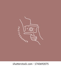 Linear logo of the photographer. Women's Hands hold the camera shutter. Abstract symbol for a photo Studio in a simple minimalistic style. Vector logo template for wedding photographer