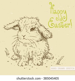 Linear sketch of the cute easter baby rabbit with green text Happy Easter. Hand drawn vintage vector illustration with lettering happy easter on the textured beige paper background.