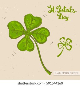 Linear sketch of the green irish lucky four-leaf clover and text congratulation St. Patrick's Day. Vector vintage hand drawn illustration on the textured paper background.