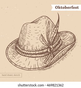 Linear sketch of the hat with feathers and text Oktoberfest. Vector vintage hand drawn illustration of the traditional german headdress on the textured paper background.