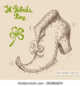 Linear sketch of the irish leprechaun shoe with clover and text congratulation St. Patrick's Day. Vector vintage hand drawn illustration on the textured paper background.