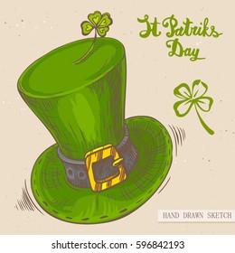 Linear sketch of the irish top hat with and text congratulation St. Patrick's Day. Vector vintage hand drawn illustration on the textured paper background.