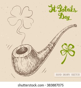 Linear sketch of the tobacco pipe with fume of four-leaf clover and text congratulation St. Patrick's Day. Vector vintage hand drawn illustration on the textured paper background.