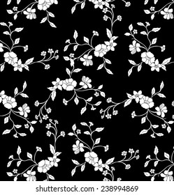Moneda de vid floral sobre fondo negro.