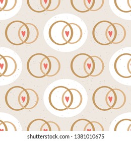 Linked gold wedding band seamless pattern with heart where rings overlap. Speckled, lightly textured tan background, fresh and modern. Perfect for invitations, stationery and gift wrapping paper.