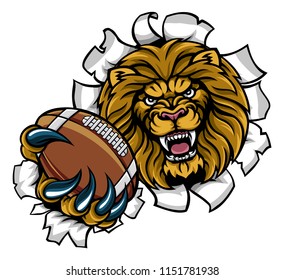 A lion angry animal sports mascot holding an American football ball and breaking through the background with its claws
