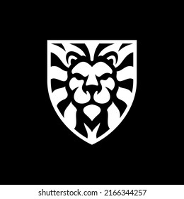 Diseño del logotipo de la cabeza de león y el emblema del escudo. Ilustración de la cabeza de león o del vector facial en el fondo oscuro