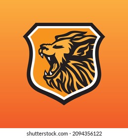 Lion logo roaring with orange in shield