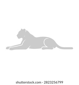 A lioness lies down in a relaxed pose looking to the left, conveying a sense of calmness and serenity in her natural habitat.