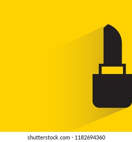 lipstick with drop shadow in yellow background