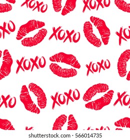 Lipstick kisses and XOXO (hugs and kisses) brush lettering seamless pattern. Illustration for Valentine's Day greeting card and decoration. Vector.