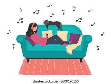 Listen to the music. Woman lays on sofa rests and listens to relax music. 
