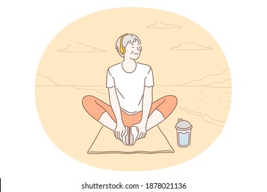 Listening to Music, recreation concept. Smiling woman in headphones sitting on fitness mat during outdoor workout and listening to favourite music enjoying weather. Music lover, melody, song, hobby