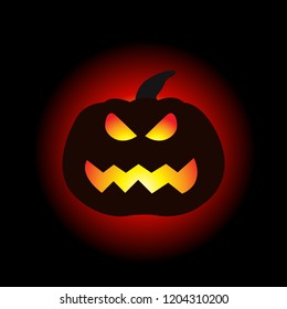 A lit Halloween pumpkin on the dark background.