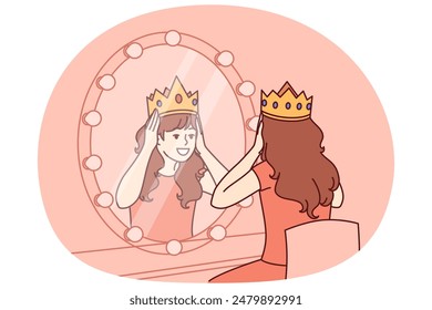 Little actress tries on crown sitting in dressing room with mirror and dreams of playing role of princess on theater stage. Teenage girl puts princess crown on head dreaming of living among kings