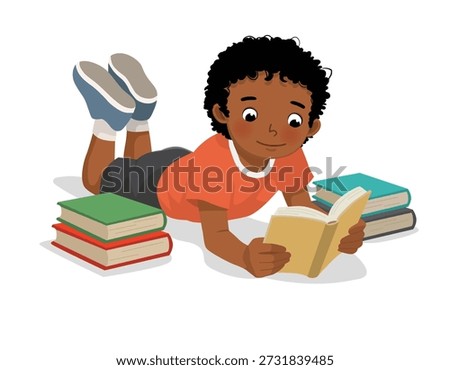 Little African boy reading book lying on the floor