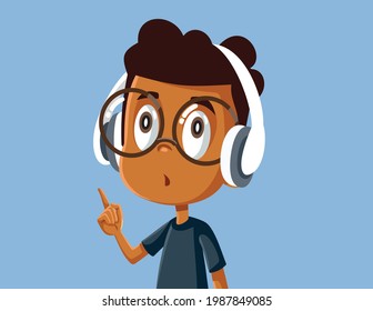 Little African Boy Wearing Headphones Listening to Music. Sweet kid wearing wireless headset pointing his finger
