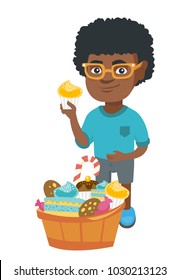 Little african-american boy holding a yummy cupcake and stroking his belly. Happy boy standing near the bowl full of sweets. Vector sketch cartoon illustration isolated on white background.