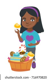 Little african-american girl holding a yummy cupcake and stroking her belly. Happy girl standing near the bowl full of sweets. Vector sketch cartoon illustration isolated on white background.