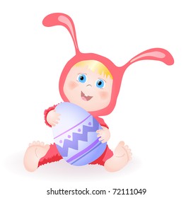 A little baby girl in bunny dress holding an egg and smiling