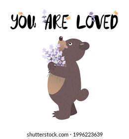 Little bear cub holding lavender bouquet and text above him You are loved decorated and flowers
