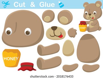 Little bear with honey jar. Cutout and gluing. Vector cartoon illustration