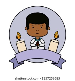 little black boy with ribbon and candles first communion