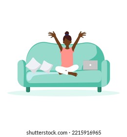 Little black girl sitting on the sofa with laptop holding her hands up. Funny active child. 