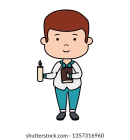 little boy with bible and candle first communion