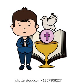 little boy with bible and chalice first communion