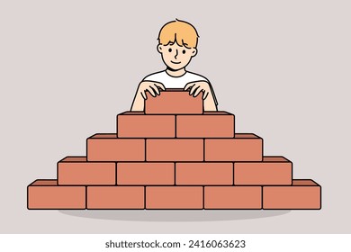 Little boy builds pyramid bricks, wanting to become builder and enroll in architectural university. Child builds sustainable structure, demonstrating architectural and engineering skills