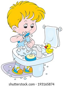 Little boy cleaning his teeth in a bathroom