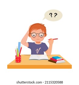 little boy confused scratching his head having problems when doing difficult math homework at the desk