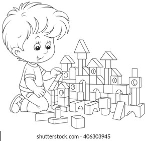 little boy constructing a toy house with bricks