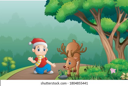 Little boy with a deer in the forest