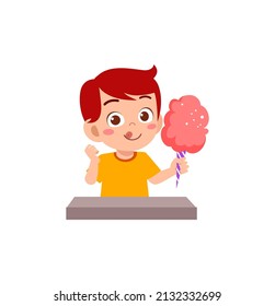 little boy eat sweet cotton candy and feel happy