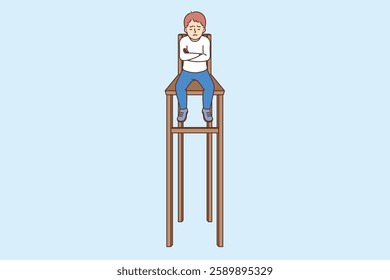 Little boy feels loneliness and isolation, sits on chair with high legs and is sad. Offended child suffers due to isolation, for concept of house arrest received as punishment for pranks