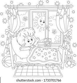 Little boy friendly smiling, waking up and stretching himself after sleep in his small bed in a nursery room with funny toys on a bright sunny morning, black and white vector cartoon illustration