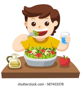 A Little boy happy to eat salad. he love vegetables.