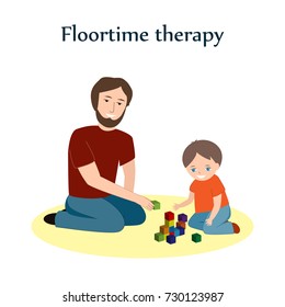 Little boy and a his father sitting on a floor and playing with blocks. Floortime therapy correction technique, used for teaching kids, especially for children with ASD or autism
