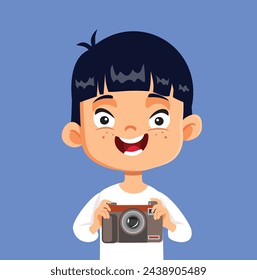 
Little Boy Holding an Analogue Camera Vector Cartoon Design. Child feeling inspired by the art of photography 
