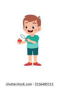 little boy holding apple and magnifying glass