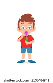 little boy holding flower and sniff the scent
