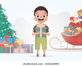 A little boy is holding a gift box. Christmas. Cartoon style. Vector illustration